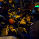 Protesters fall on the ground as they are chased by riot police in Mong Kok on Nov. 29, 2014.
